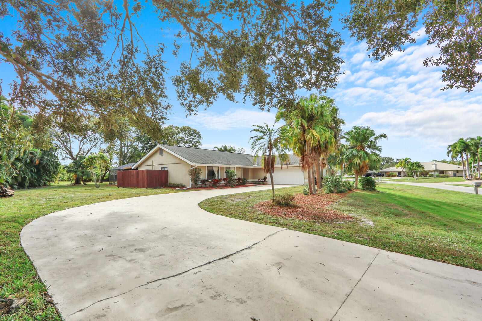 3060 Southeast Darien Road Port St. Lucie, FL 34952 - Photo 52 of 56 a front view of a house with a yard and trees