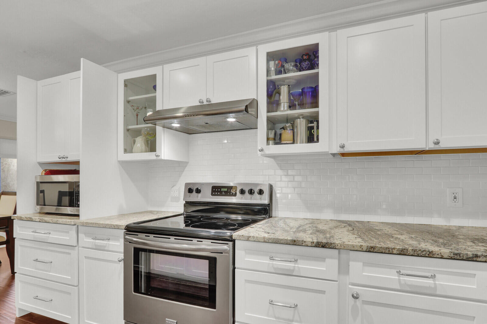 3060 Southeast Darien Road Port St. Lucie, FL 34952 - Photo 9 of 56 a kitchen with stainless steel appliances granite countertop white cabinets and a stove