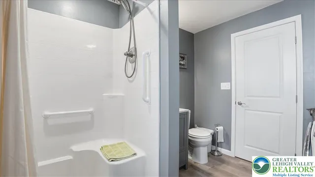 a bathroom with a sink a toilet and shower