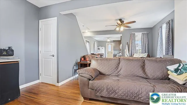 a dining room with furniture and wooden floor