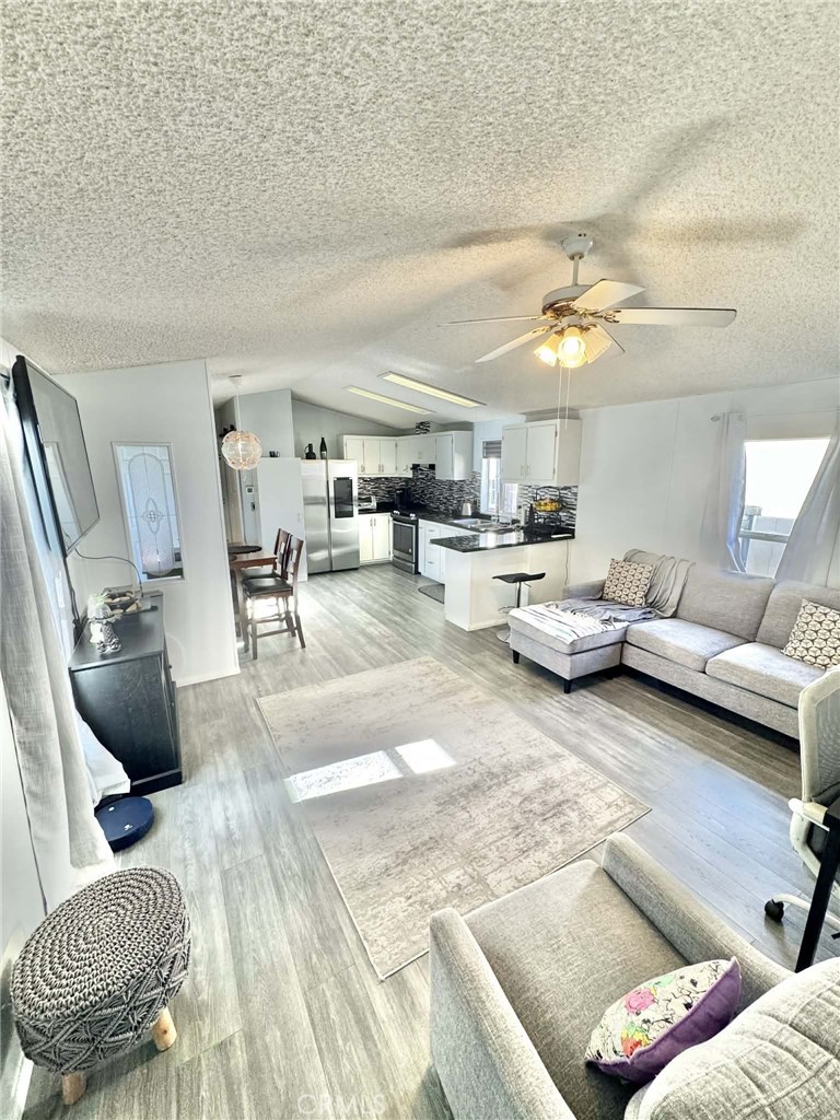 8811 Park Street, Unit 54 Bellflower, CA 90706 - Photo 5 of 13 a living room with furniture and a chandelier