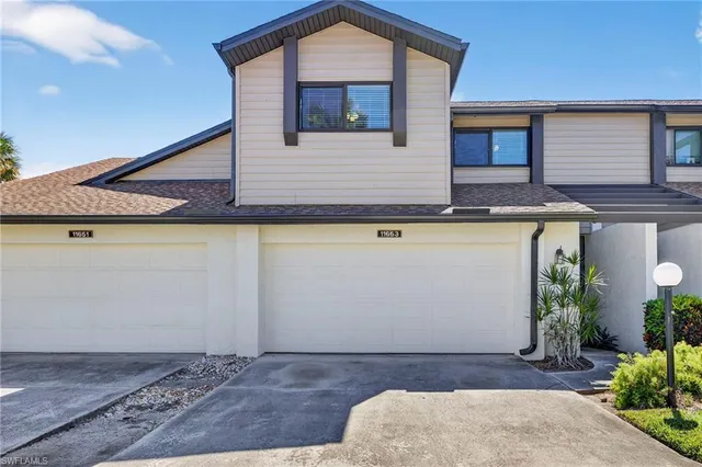 a front view of a house with garage