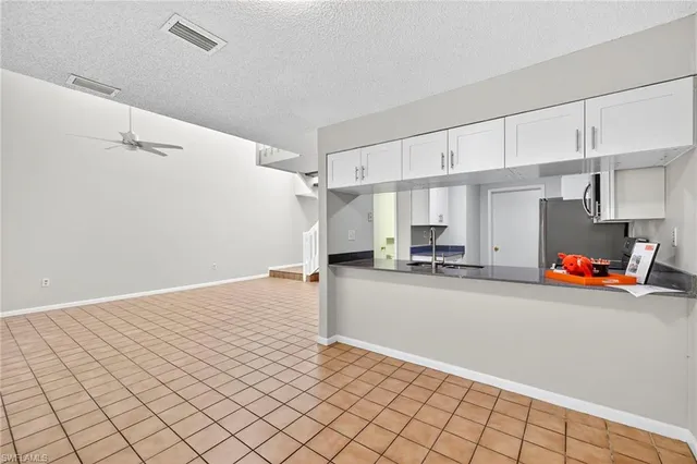 a kitchen with stainless steel appliances granite countertop a refrigerator sink and stove