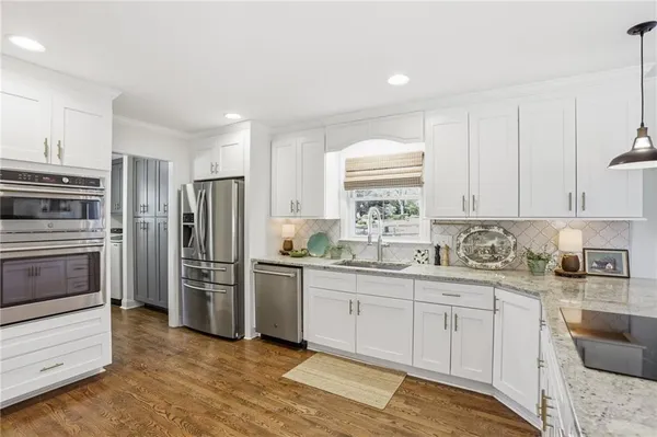a kitchen with a sink stove and refrigerator