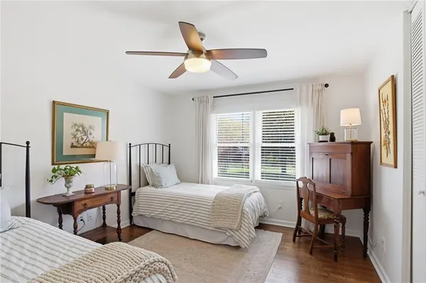 a bedroom with a bed a table and chair