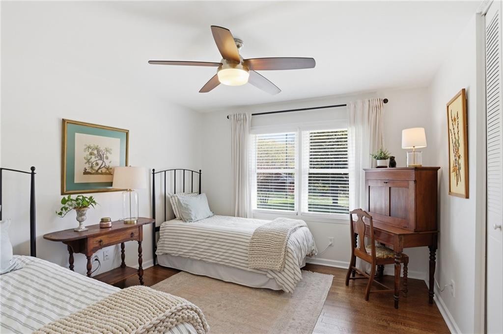 555 Allgood Road Northeast Marietta, GA 30060 - Photo 18 of 32 a bedroom with a bed a table and chair