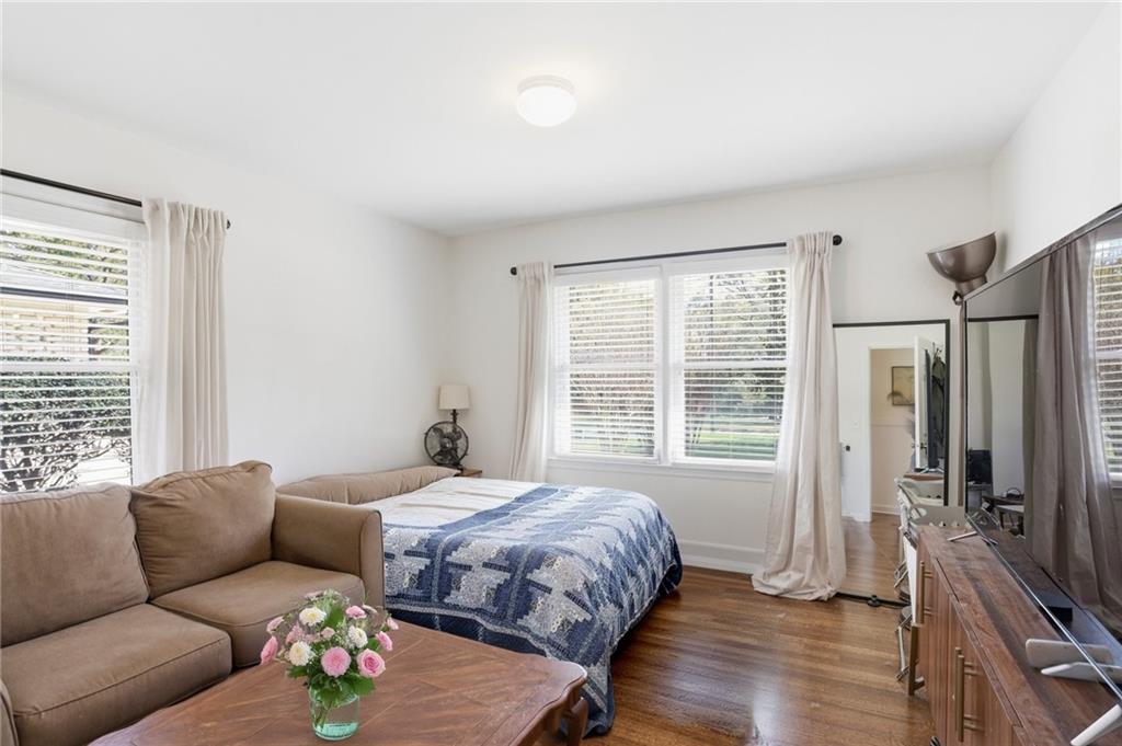555 Allgood Road Northeast Marietta, GA 30060 - Photo 20 of 32 a bedroom with a bed couches and a flat tv screen