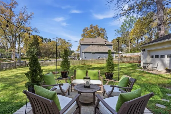 a view of a patio with couches chairs and a big yard