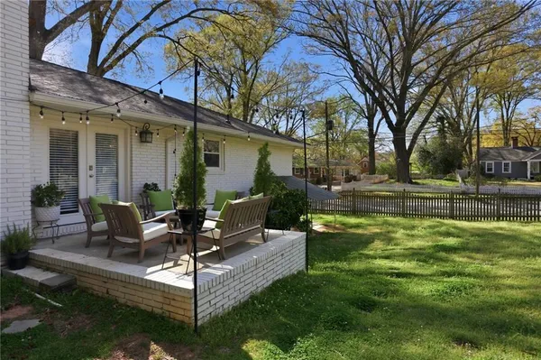 a view of a house with a yard patio and fire pit