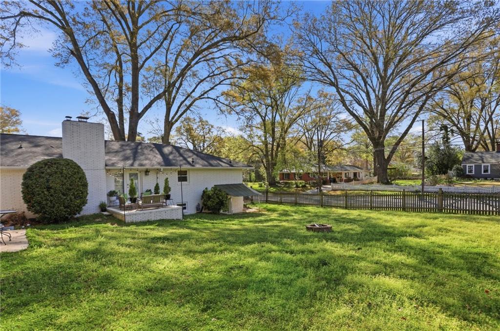 555 Allgood Road Northeast Marietta, GA 30060 - Photo 29 of 32 a view of a backyard with table and chairs and a fire pit