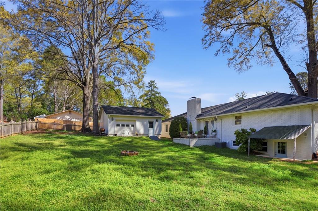 555 Allgood Road Northeast Marietta, GA 30060 - Photo 30 of 32 a view of a house with a big yard and large trees