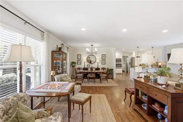 a living room with furniture a rug and a large window
