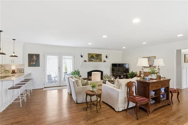 a living room with fireplace furniture and a wooden floor