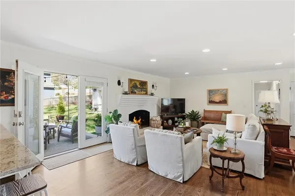 a living room with furniture a fireplace and a table