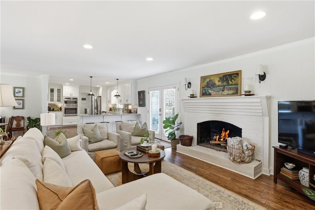 555 Allgood Road Northeast Marietta, GA 30060 - Photo 9 of 32 a living room with furniture a fireplace and a fireplace