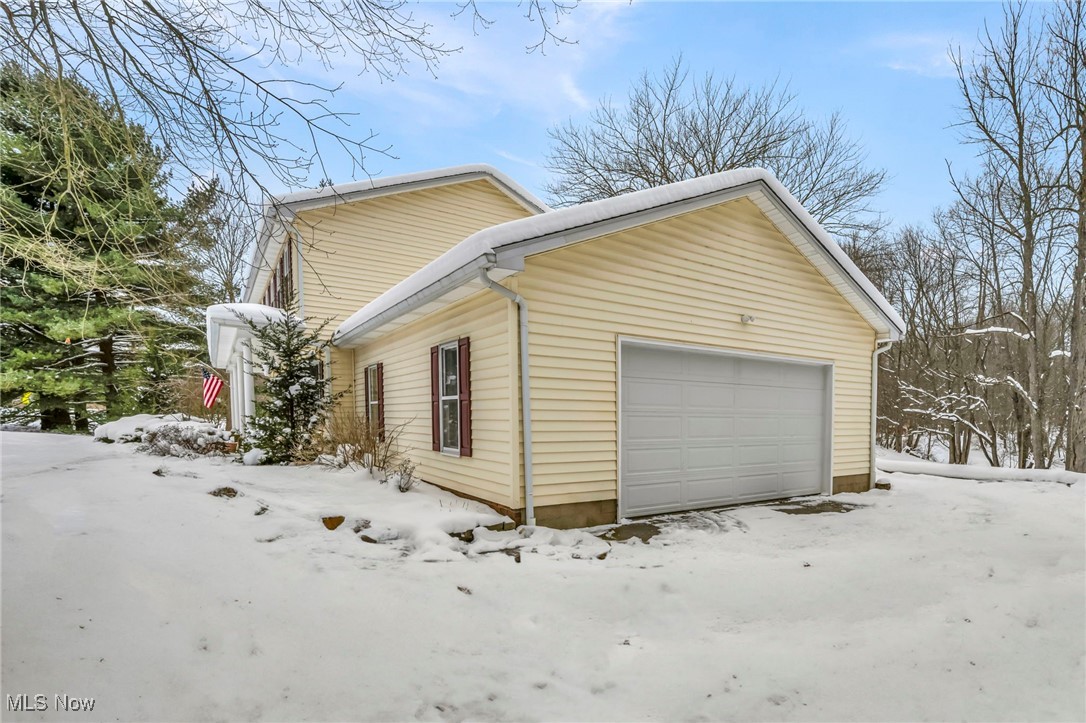 167 Spell Road Kent, OH 44240 - Photo 45 of 48 View of snow covered exterior featuring a 2 car garage