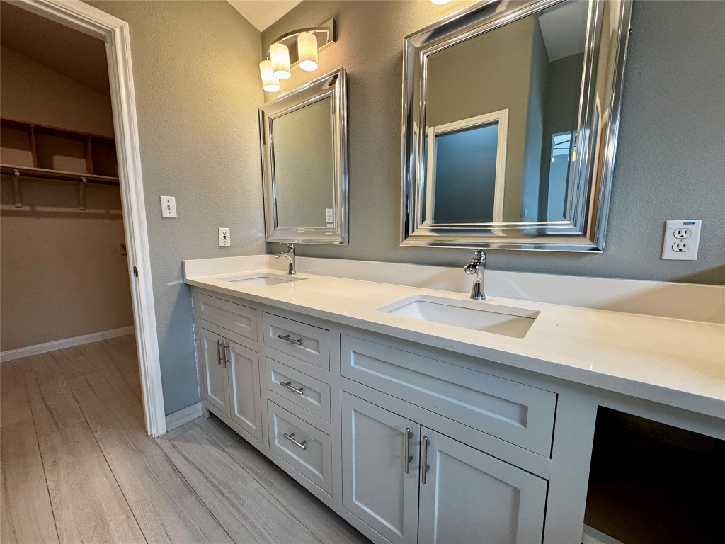 104 Silk Tree Lane Round Rock, TX 78664 - Photo 14 of 29 a spacious bathroom with a double vanity sink and a mirror