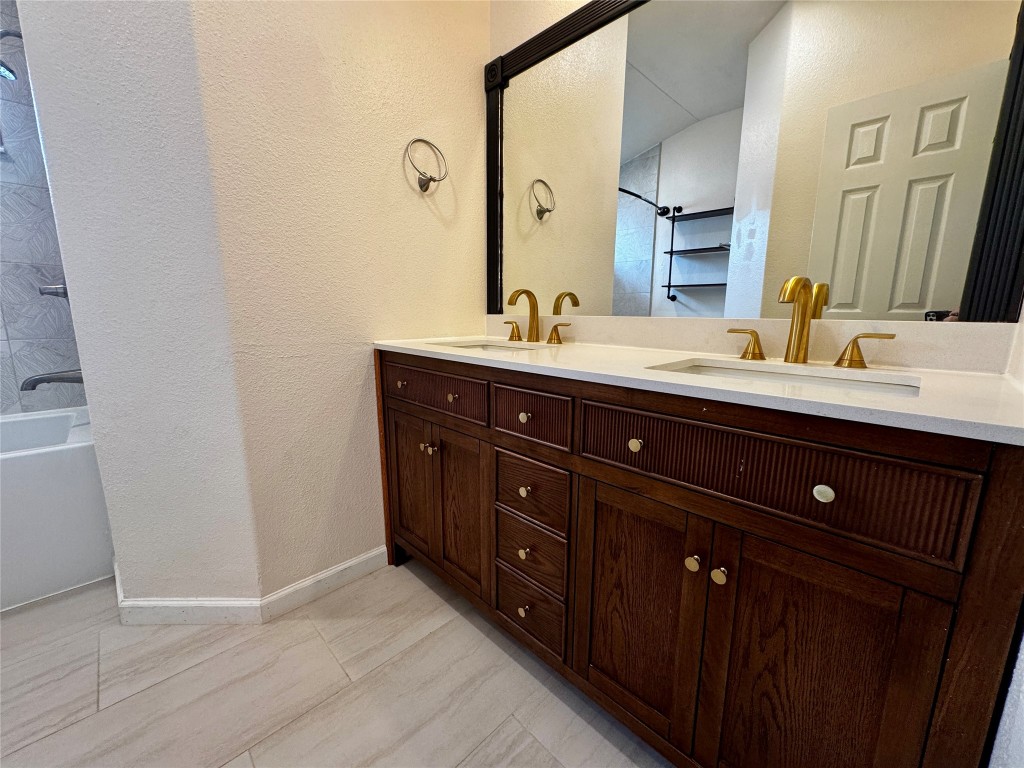 104 Silk Tree Lane Round Rock, TX 78664 - Photo 19 of 29 a bathroom with a double vanity sink and mirror