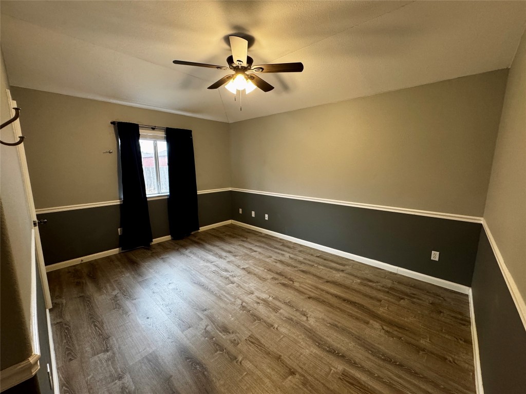 104 Silk Tree Lane Round Rock, TX 78664 - Photo 21 of 29 an empty room with wooden floor and windows
