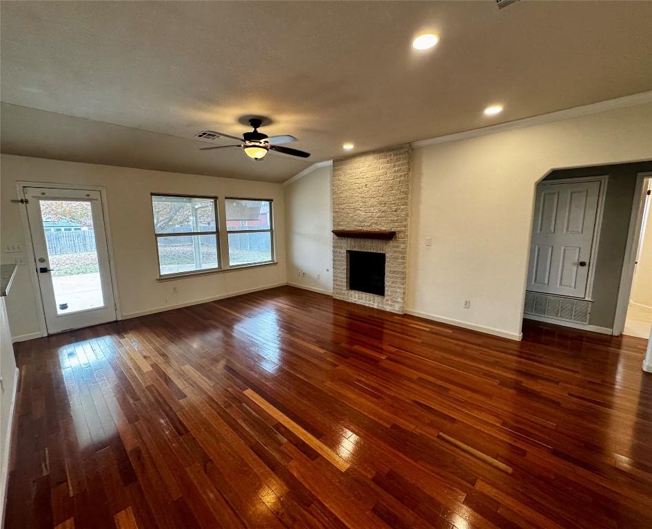 104 Silk Tree Lane Round Rock, TX 78664 - Photo 3 of 29 a view of an empty room with wooden floor and a window