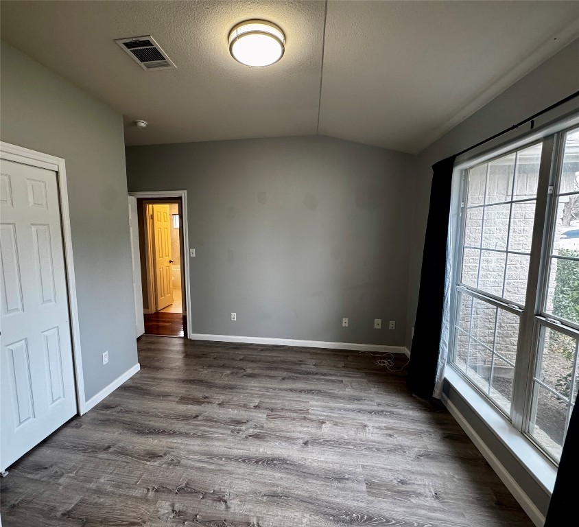 104 Silk Tree Lane Round Rock, TX 78664 - Photo 8 of 29 an empty room with wooden floor and windows