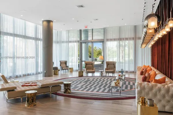 a living room with furniture and large windows