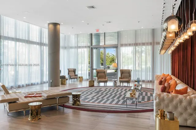 a living room with furniture and large windows