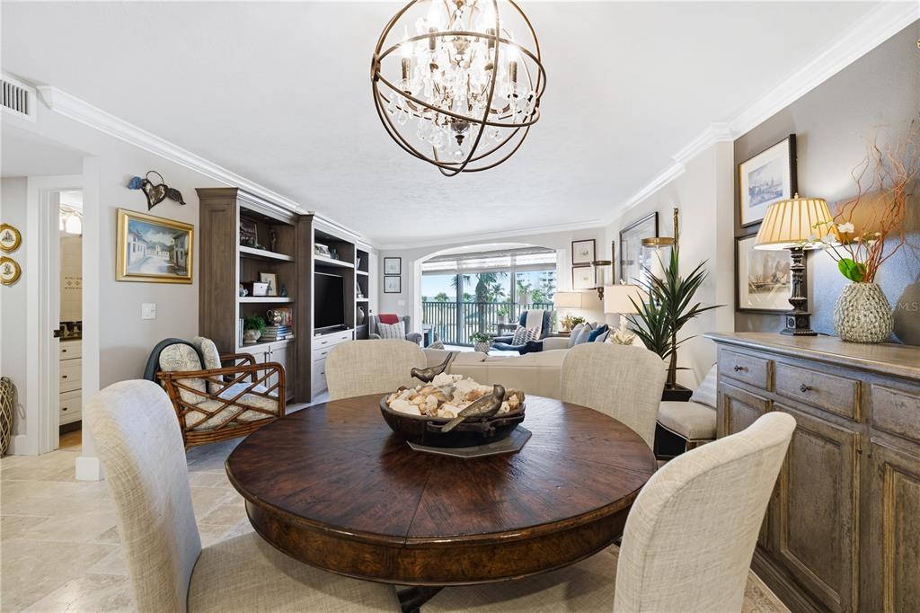 5880 Midnight Pass Road, Unit 302 Sarasota, FL 34242 - Photo 16 of 97 a living room with furniture a chandelier and a large window