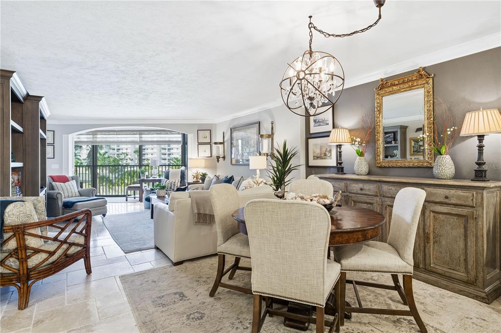 5880 Midnight Pass Road, Unit 302 Sarasota, FL 34242 - Photo 17 of 97 a dining room with furniture a chandelier and wooden floor