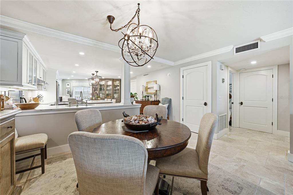 5880 Midnight Pass Road, Unit 302 Sarasota, FL 34242 - Photo 18 of 97 a dining room with furniture a rug and a chandelier
