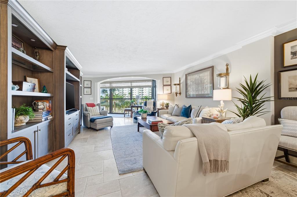 5880 Midnight Pass Road, Unit 302 Sarasota, FL 34242 - Photo 22 of 97 a living room with furniture a flat screen tv and a window
