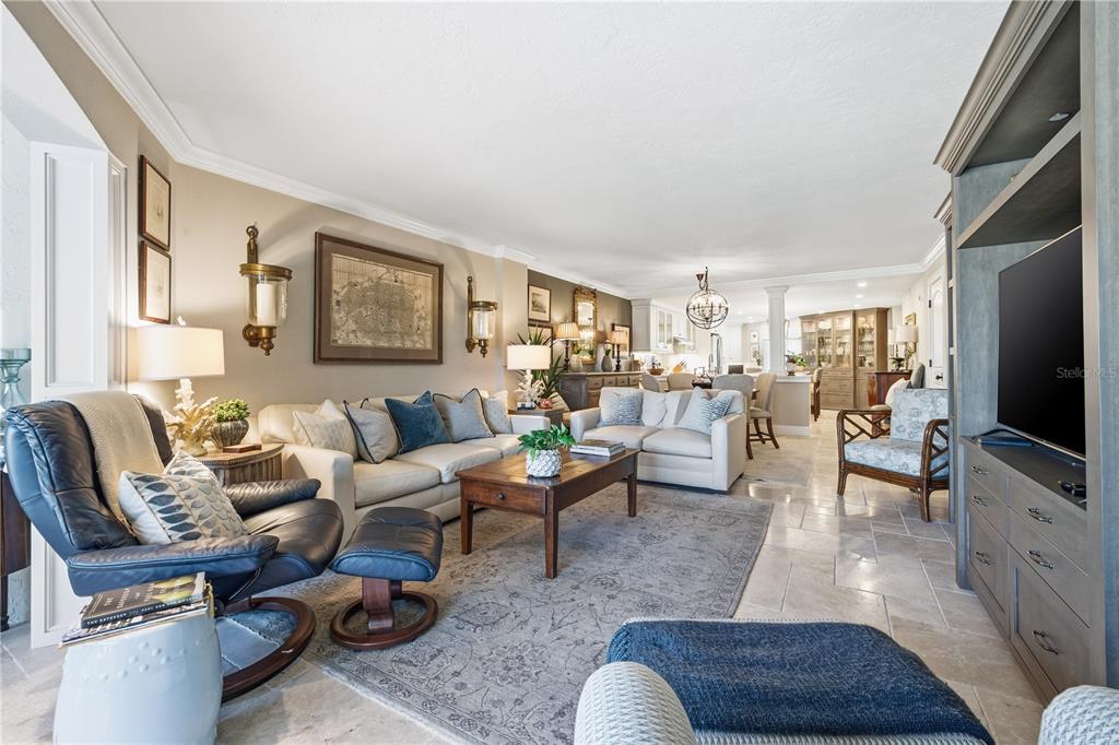 5880 Midnight Pass Road, Unit 302 Sarasota, FL 34242 - Photo 24 of 97 a living room with furniture and a flat screen tv