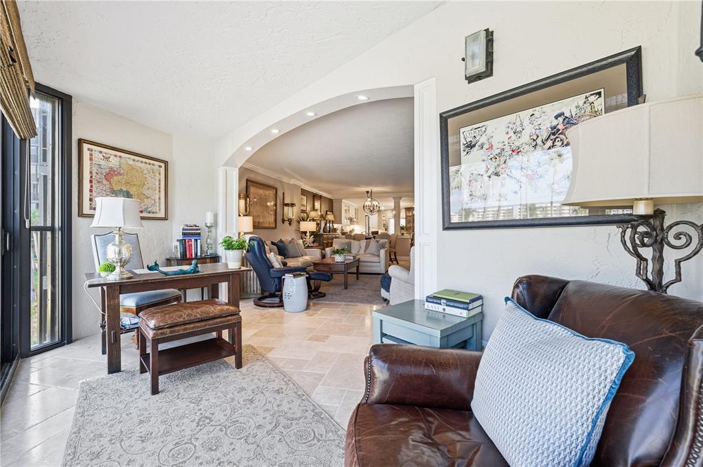 5880 Midnight Pass Road, Unit 302 Sarasota, FL 34242 - Photo 25 of 97 a living room with furniture and a painting on the wall