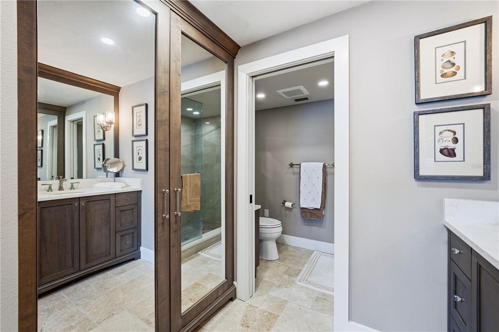 5880 Midnight Pass Road, Unit 302 Sarasota, FL 34242 - Photo 33 of 97 a bathroom with a glass door shower and a sink