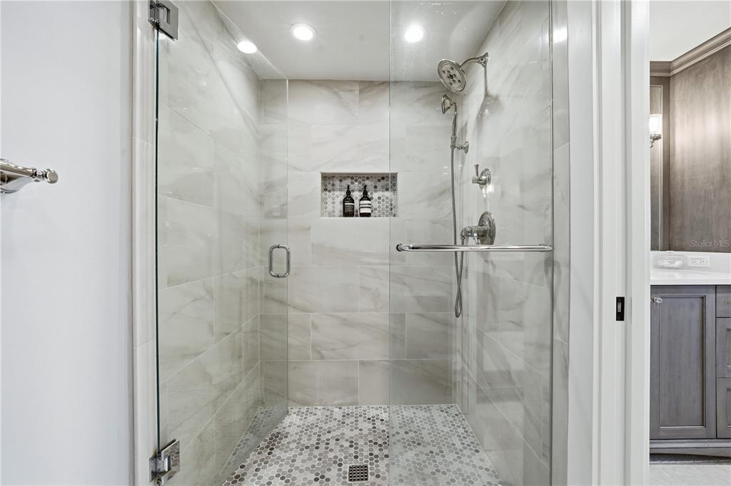 5880 Midnight Pass Road, Unit 302 Sarasota, FL 34242 - Photo 35 of 97 a bathroom with a shower