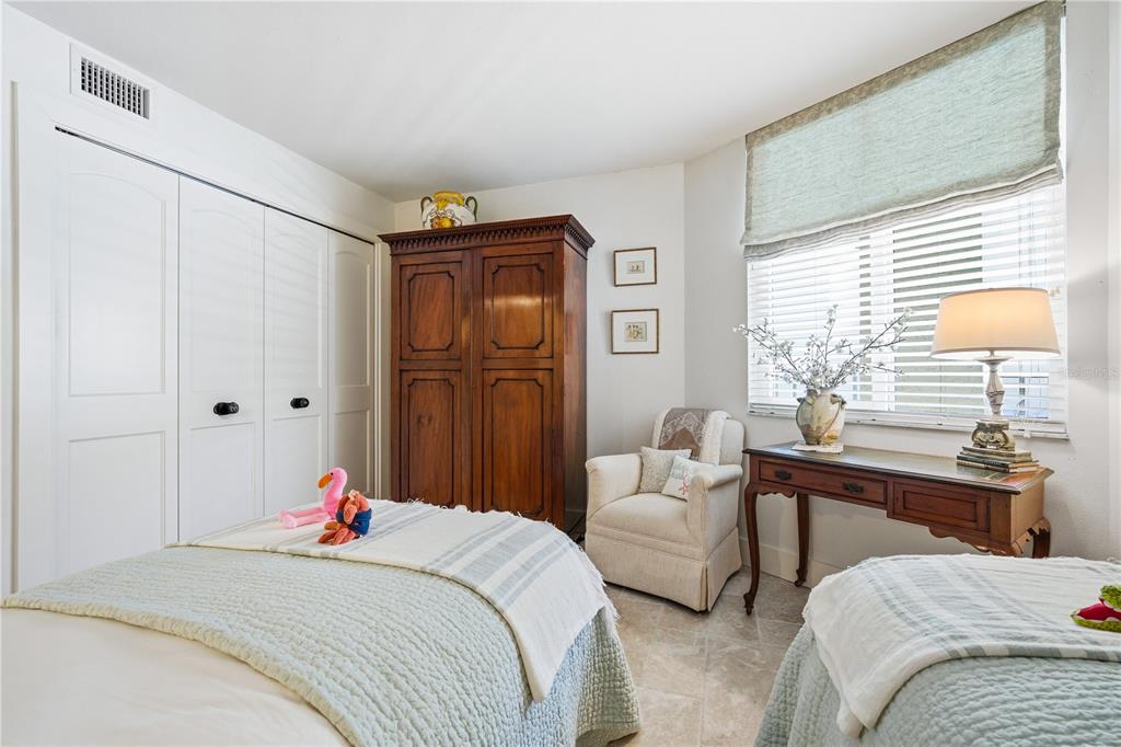 5880 Midnight Pass Road, Unit 302 Sarasota, FL 34242 - Photo 37 of 97 a bedroom with a bed and a table