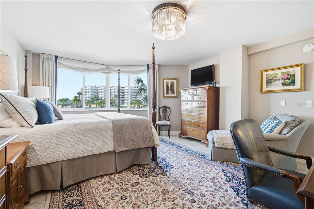 5880 Midnight Pass Road, Unit 302 Sarasota, FL 34242 - Photo 4 of 97 a living room with furniture a flat screen tv and a large window