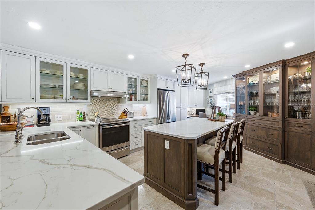 5880 Midnight Pass Road, Unit 302 Sarasota, FL 34242 - Photo 5 of 97 a kitchen with a table and chairs in it