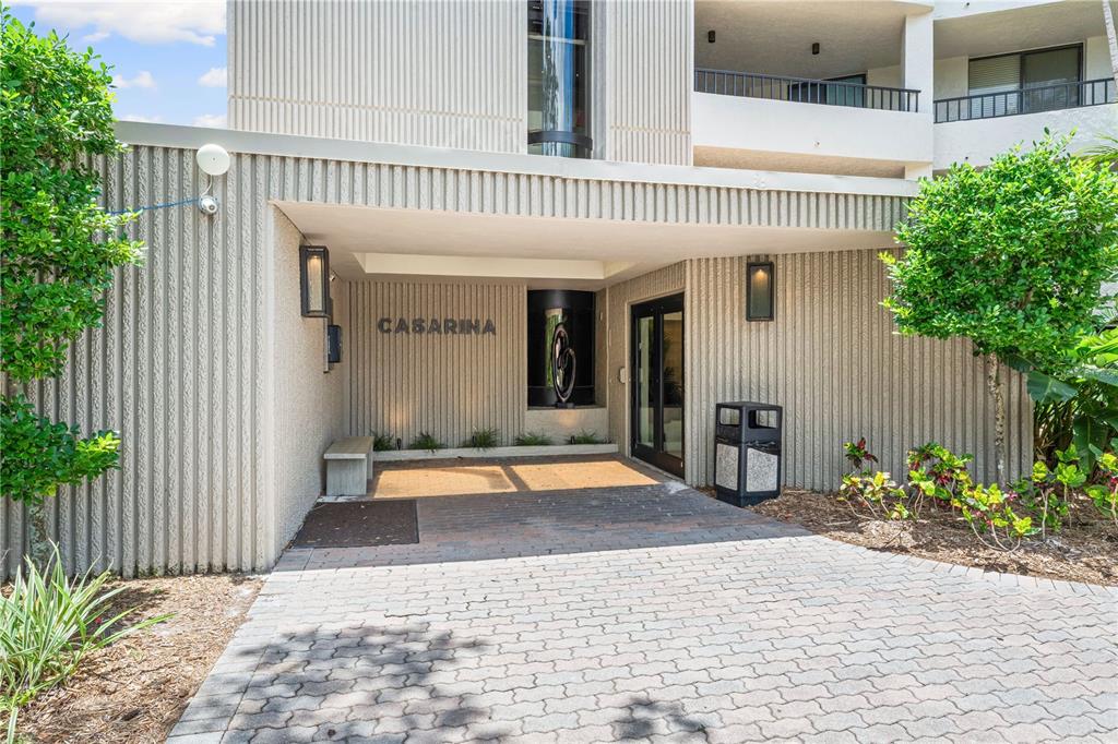 5880 Midnight Pass Road, Unit 302 Sarasota, FL 34242 - Photo 54 of 97 a swimming pool with potted plants and wooden fence