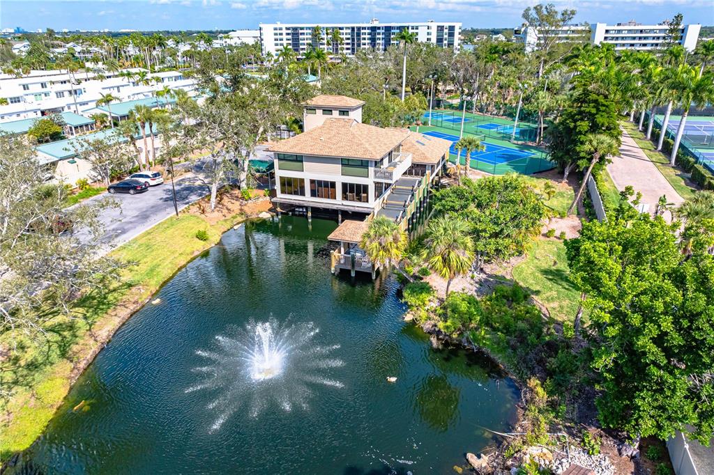 5880 Midnight Pass Road, Unit 302 Sarasota, FL 34242 - Photo 57 of 97 a balcony with swimming pool and lake view