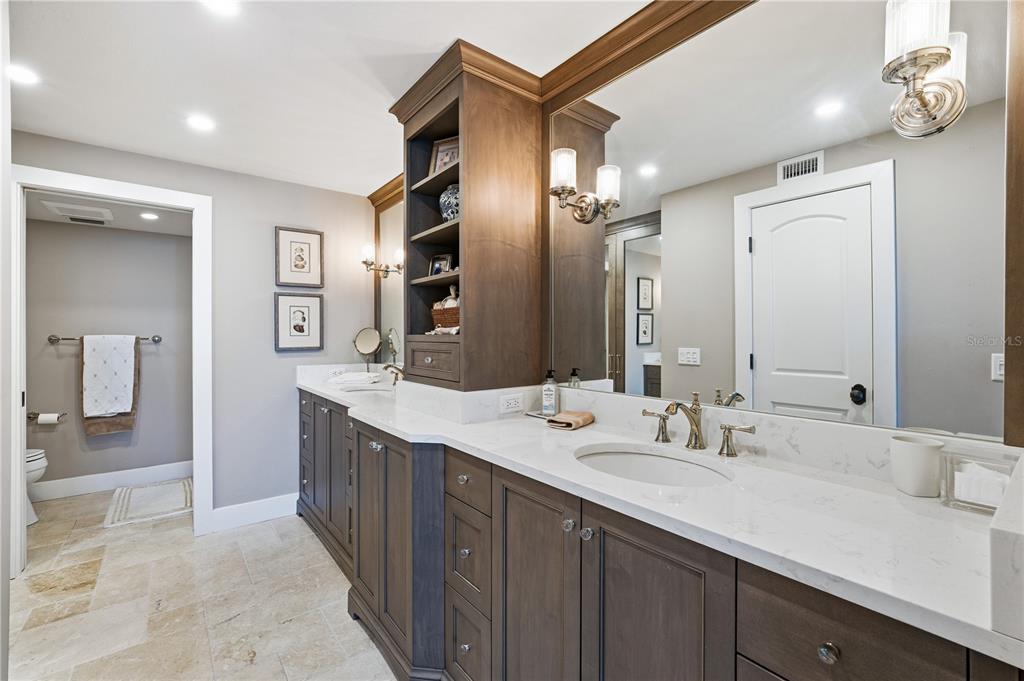 5880 Midnight Pass Road, Unit 302 Sarasota, FL 34242 - Photo 6 of 97 a bathroom with a double vanity sink a mirror and a shower