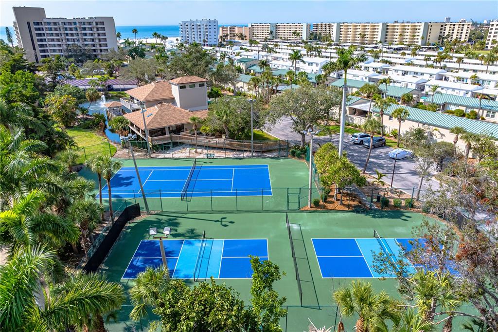 5880 Midnight Pass Road, Unit 302 Sarasota, FL 34242 - Photo 64 of 97 an aerial view of multiple houses with yard