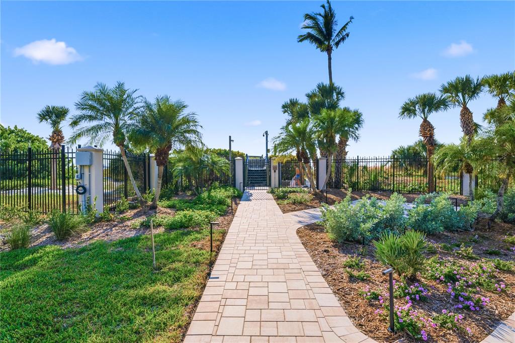5880 Midnight Pass Road, Unit 302 Sarasota, FL 34242 - Photo 76 of 97 a front view of a house with garden