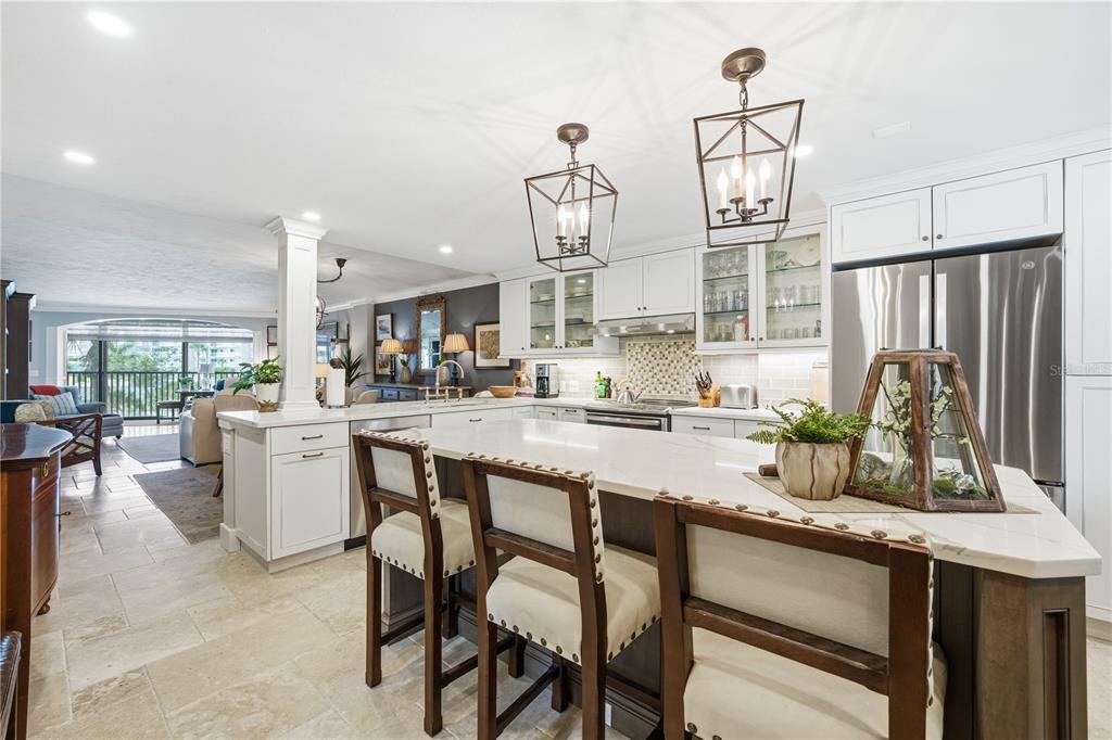 5880 Midnight Pass Road, Unit 302 Sarasota, FL 34242 - Photo 10 of 97 a kitchen with a sink cabinets and window