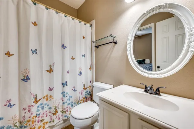 a bedroom with a large bed and a ceiling fan