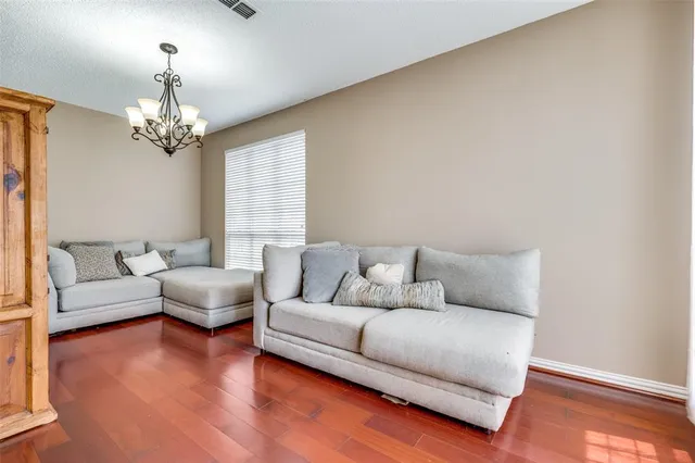 a living room with furniture and a chandelier