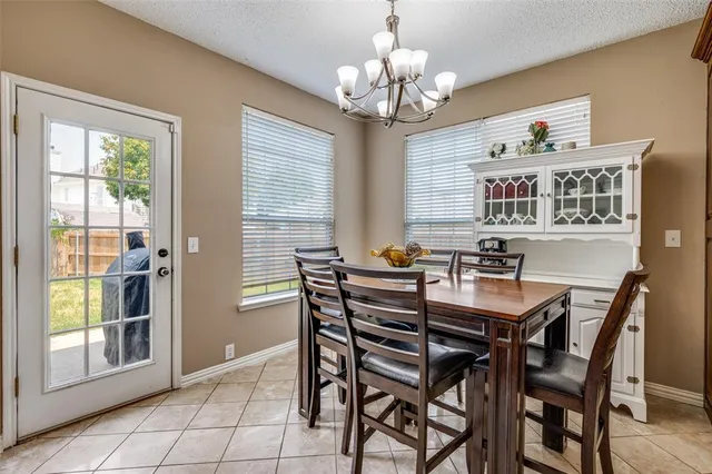 a view of a dining room with furniture wooden floor and chandelier