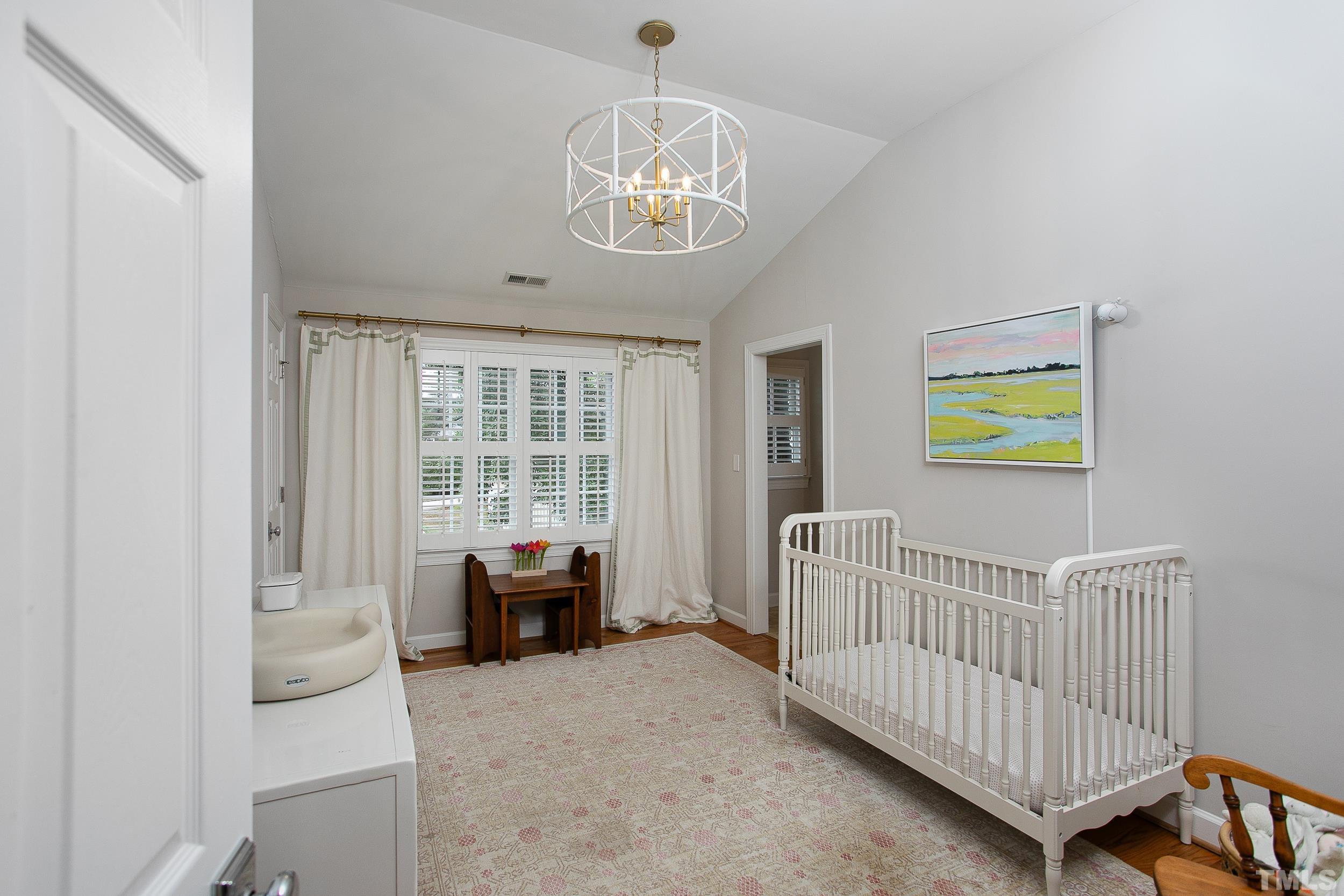 632 New Road Raleigh, NC 27608 - Photo 22 of 35 a bedroom with furniture and a window