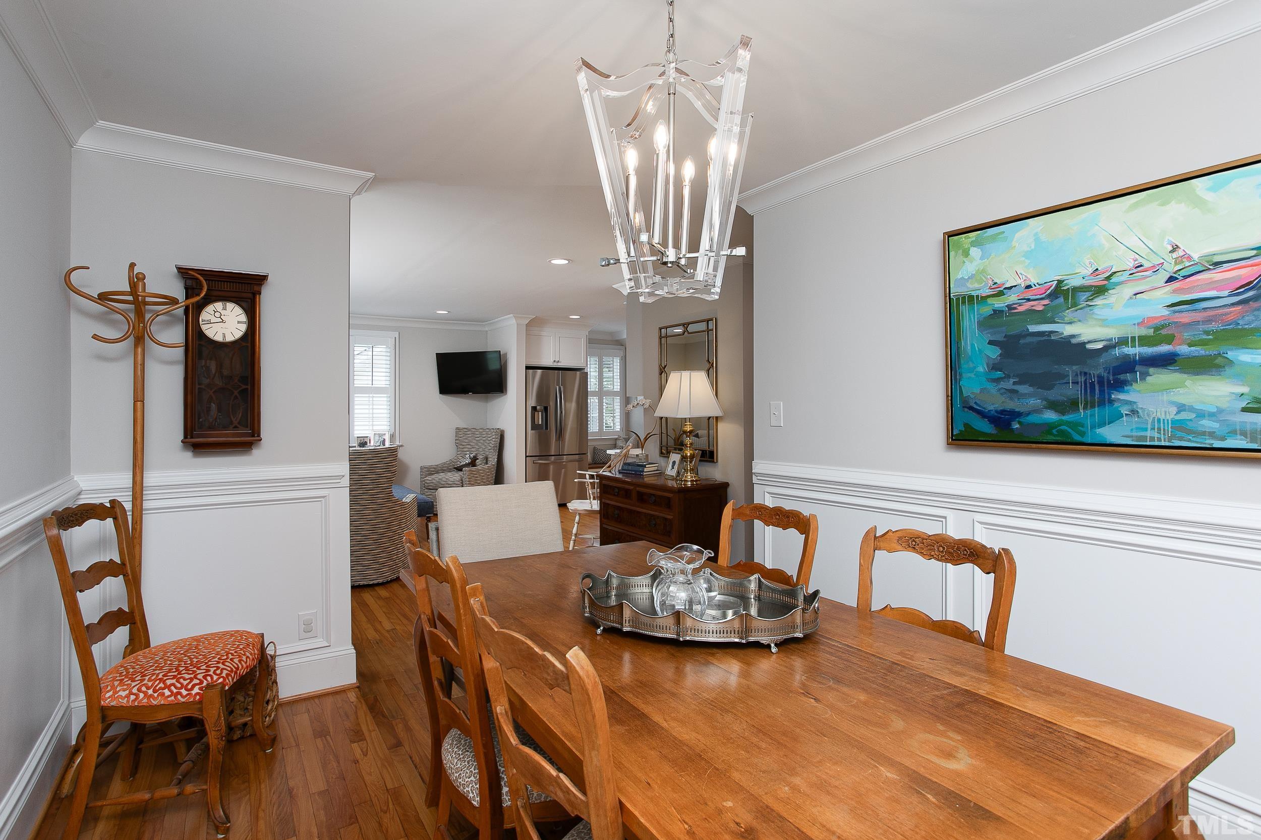 632 New Road Raleigh, NC 27608 - Photo 5 of 35 a view of a dining room with furniture a chandelier and wooden floor
