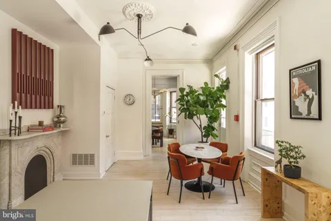 a dining room with furniture and window